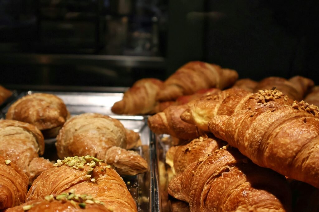 A tempting display of fresh croissants in a Milano bakery, perfect for breakfast.